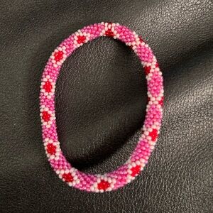 Sashka bracelet stretches up to 7  1/2 red, white, pink diamond shape.
